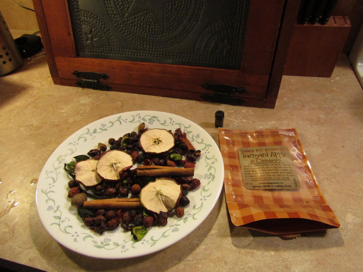 Shoots Roots and Leather Boots cinnamon simmering potpourri with dried fruit and spices on a plate next to packaging