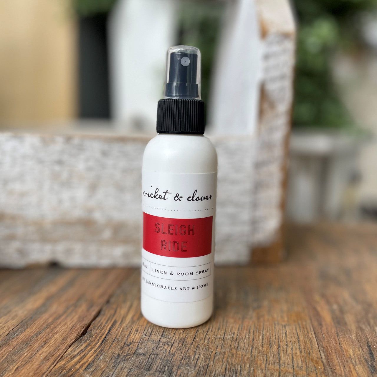 Cricket and Clover Sleigh Ride linen and room spray on wood surface holiday scented home spray for rooms and linens