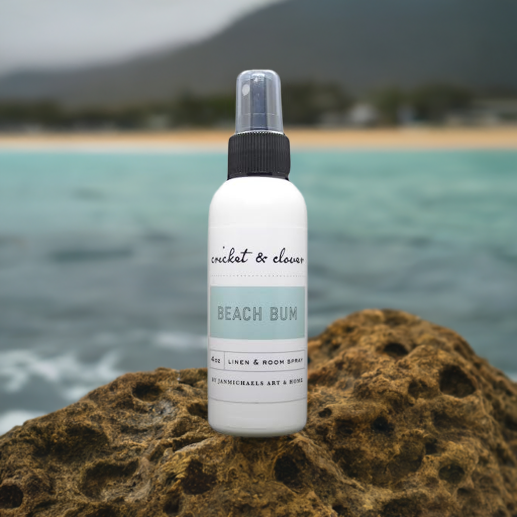 Cricket & Clover home fragrance beach scent linen and room spray bottle on a rock by the ocean