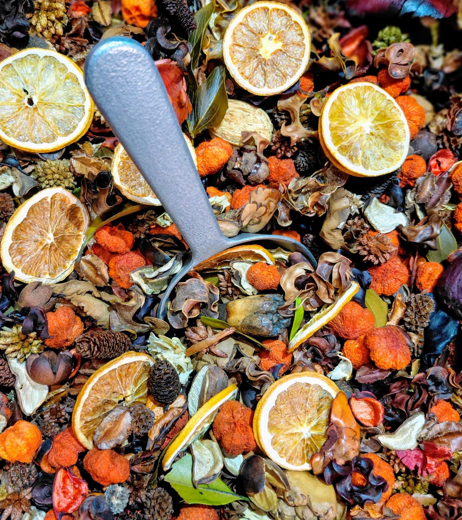 Handcrafted Sweet Orange potpourri with dried orange slices and mixed natural botanicals in a scoop