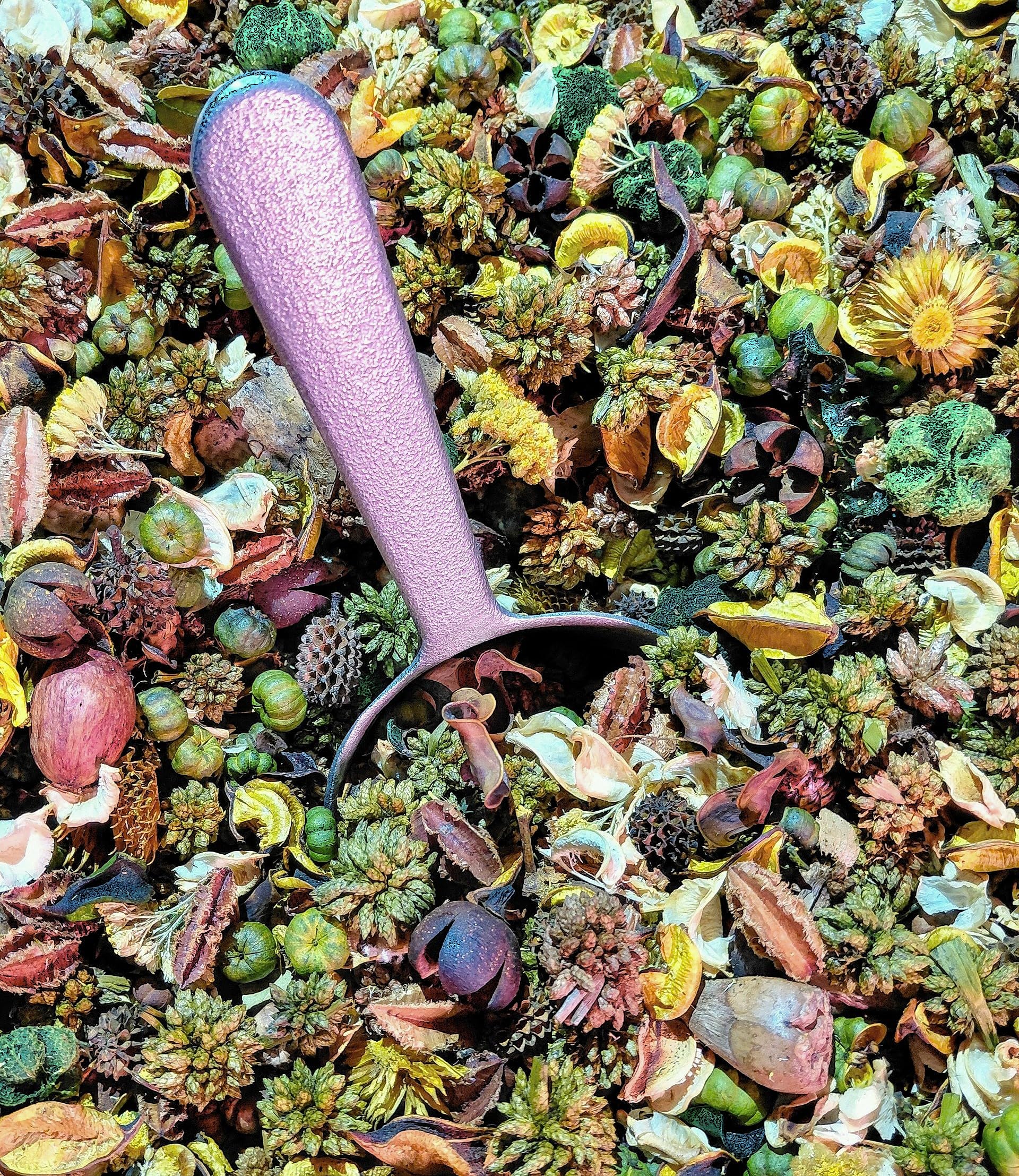 Honeysuckle potpourri blend with mixed dried flowers and pine cones and a pink scoop