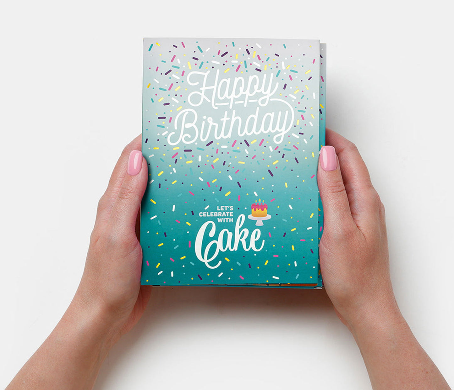 Hands holding a unique birthday gift card with colorful sprinkles and Happy Birthday text
