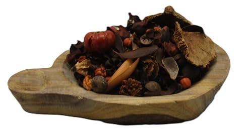 Pumpkin spice potpourri with dried leaves and miniature pumpkins in a rustic wooden bowl