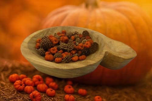 Decorative autumn bowl filler with pine cones and miniature pumpkins in wooden bowl with pumpkin background