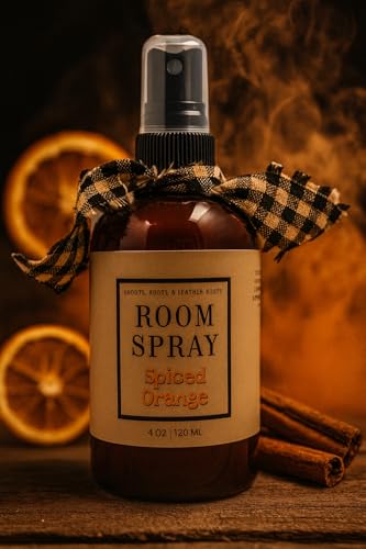 Amber spray bottle labeled spiced orange room spray with dried orange slices and cinnamon sticks