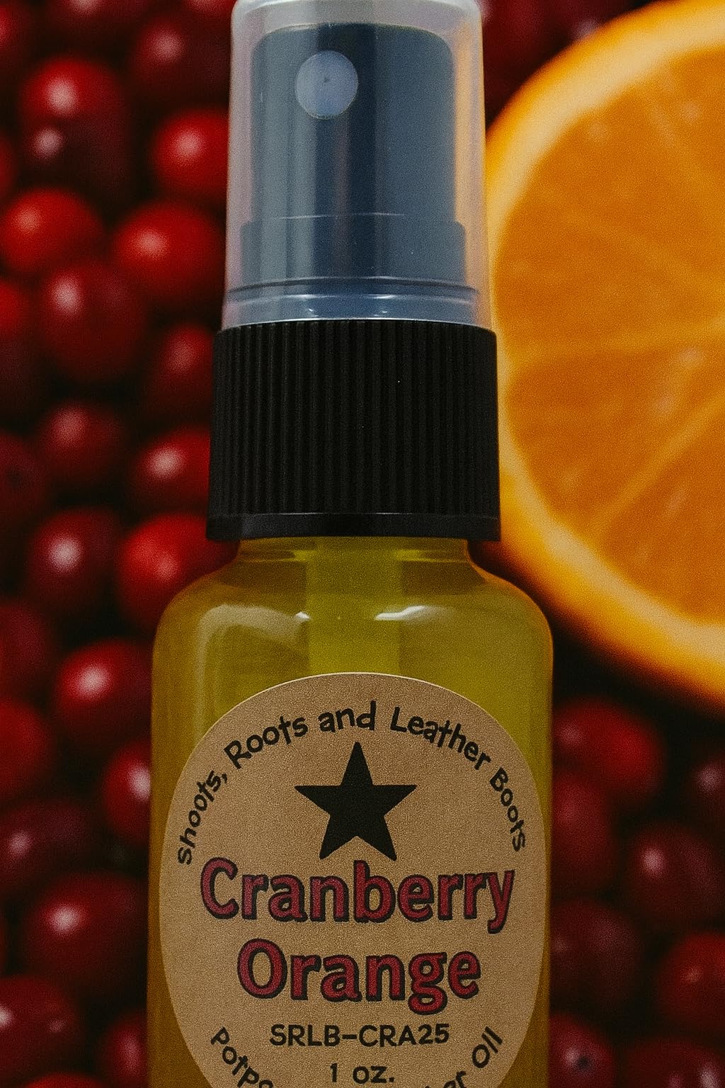 Shoots Roots and Leather Boots cranberry orange potpourri refresher spray oil bottle with cranberries and orange slice background