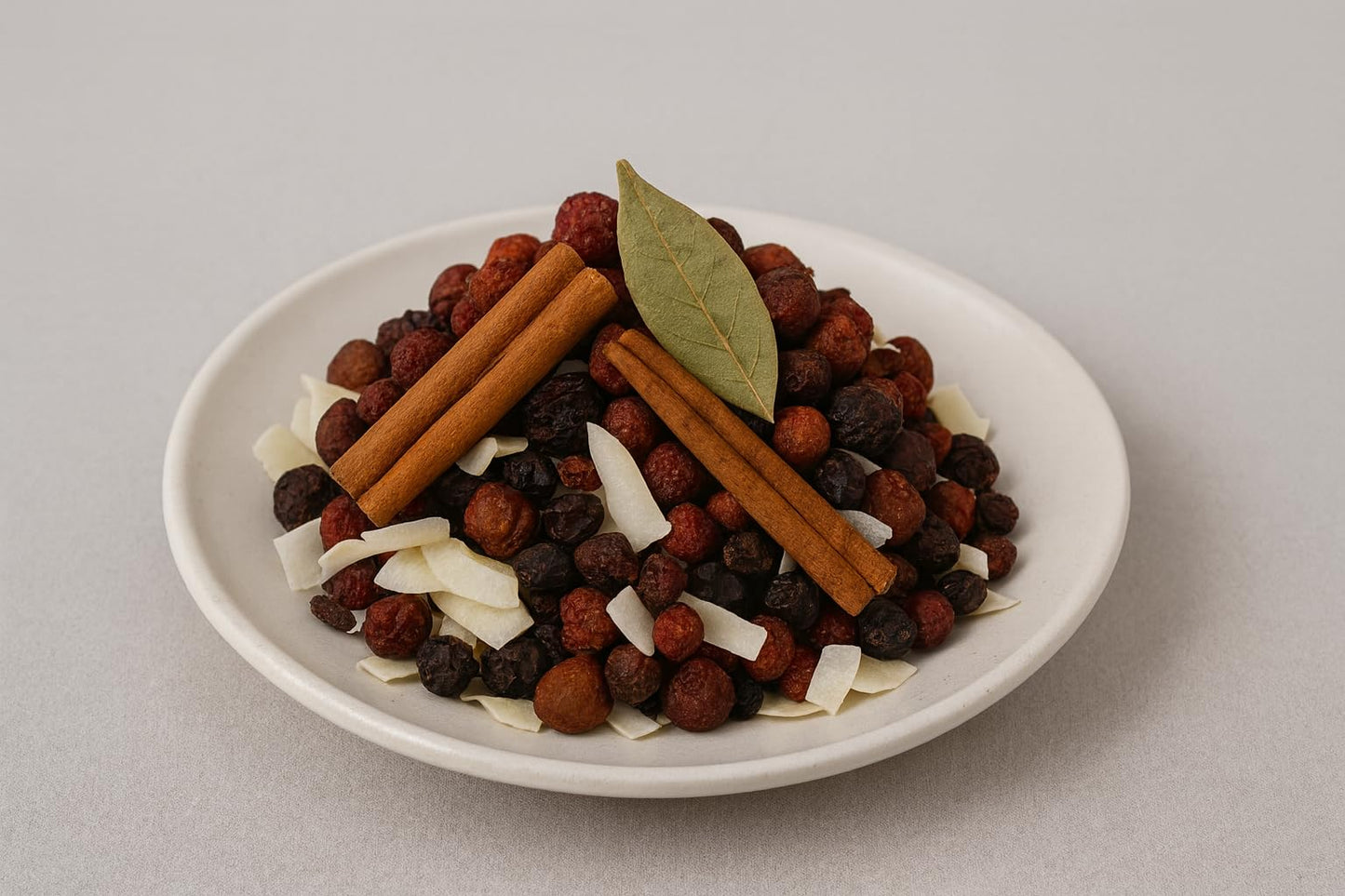 Spiced cranberry simmer potpourri with cinnamon sticks and dried fruits in a white bowl