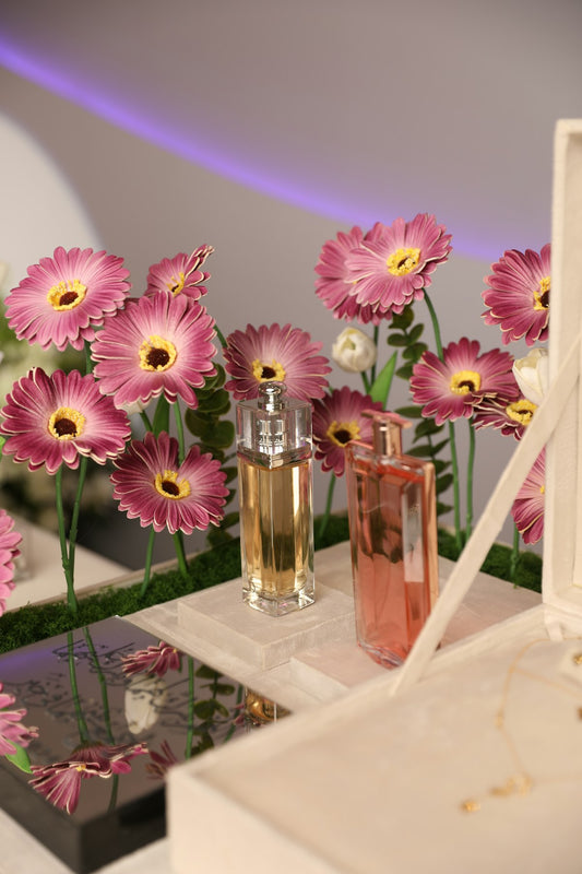 Bottle of perfume with dried flowers on a table – potpourri home fragrance