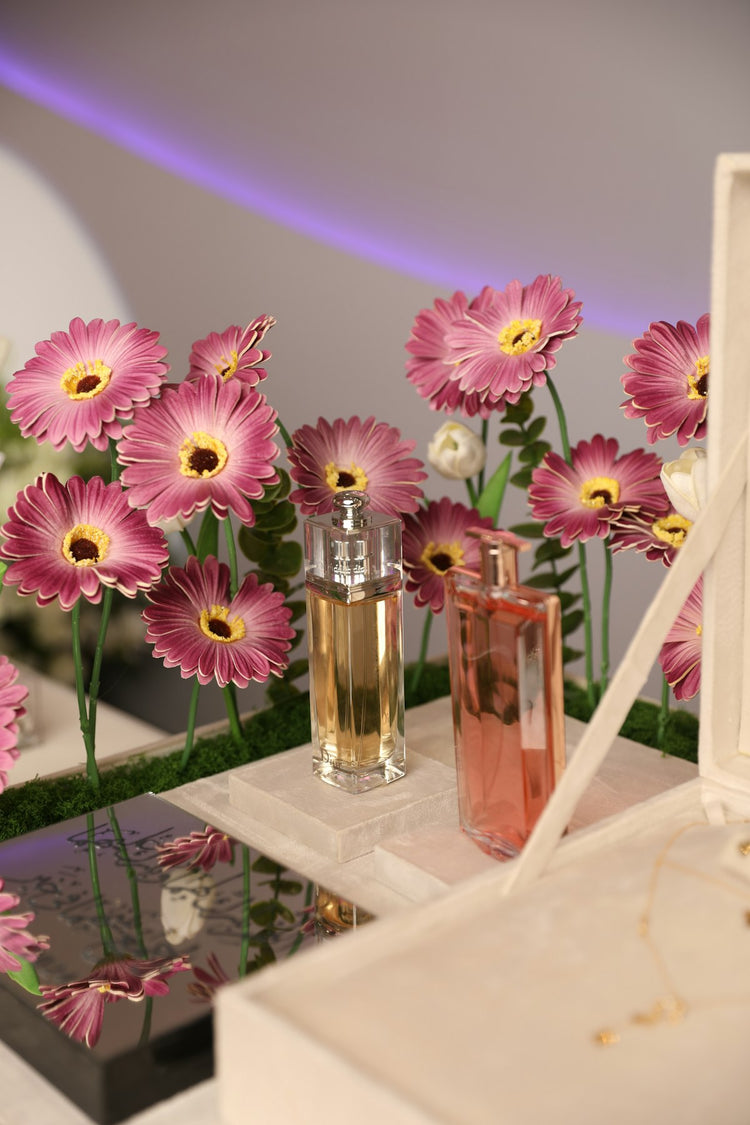 Bottle of perfume with dried flowers on a table – potpourri home fragrance