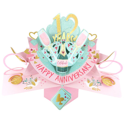 12th anniversary pop-up card featuring champagne glasses and festive decorations for celebration