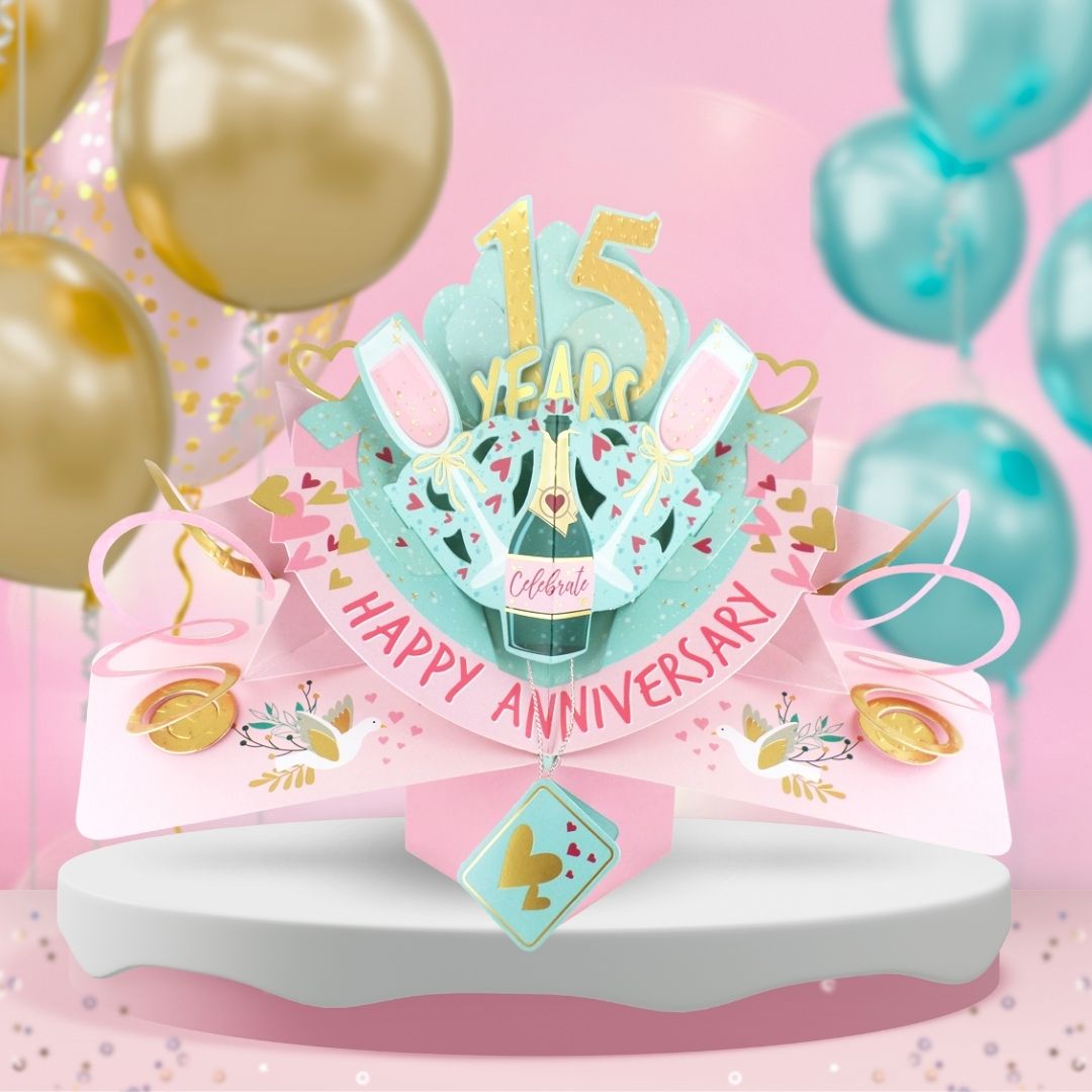 15th anniversary pop up card with champagne glasses and colorful decorations for celebration