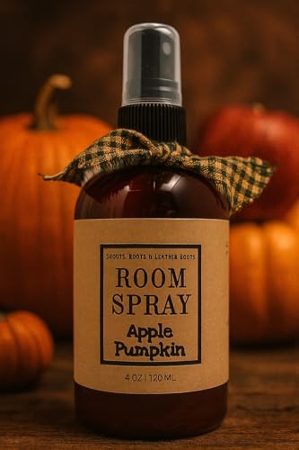 Amber spray bottle labeled Apple Pumpkin room spray with plaid fabric tie and pumpkins in warm background