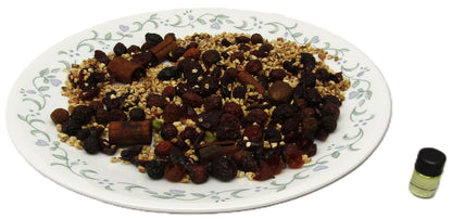 Colorful dried fruit and nut mixture with oats on a decorative plate, featuring a small essential oil bottle