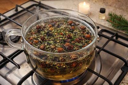 Shoots, Roots & Leather Boots Enchanted Forest Simmer Potpourri in a clear pot on a stove