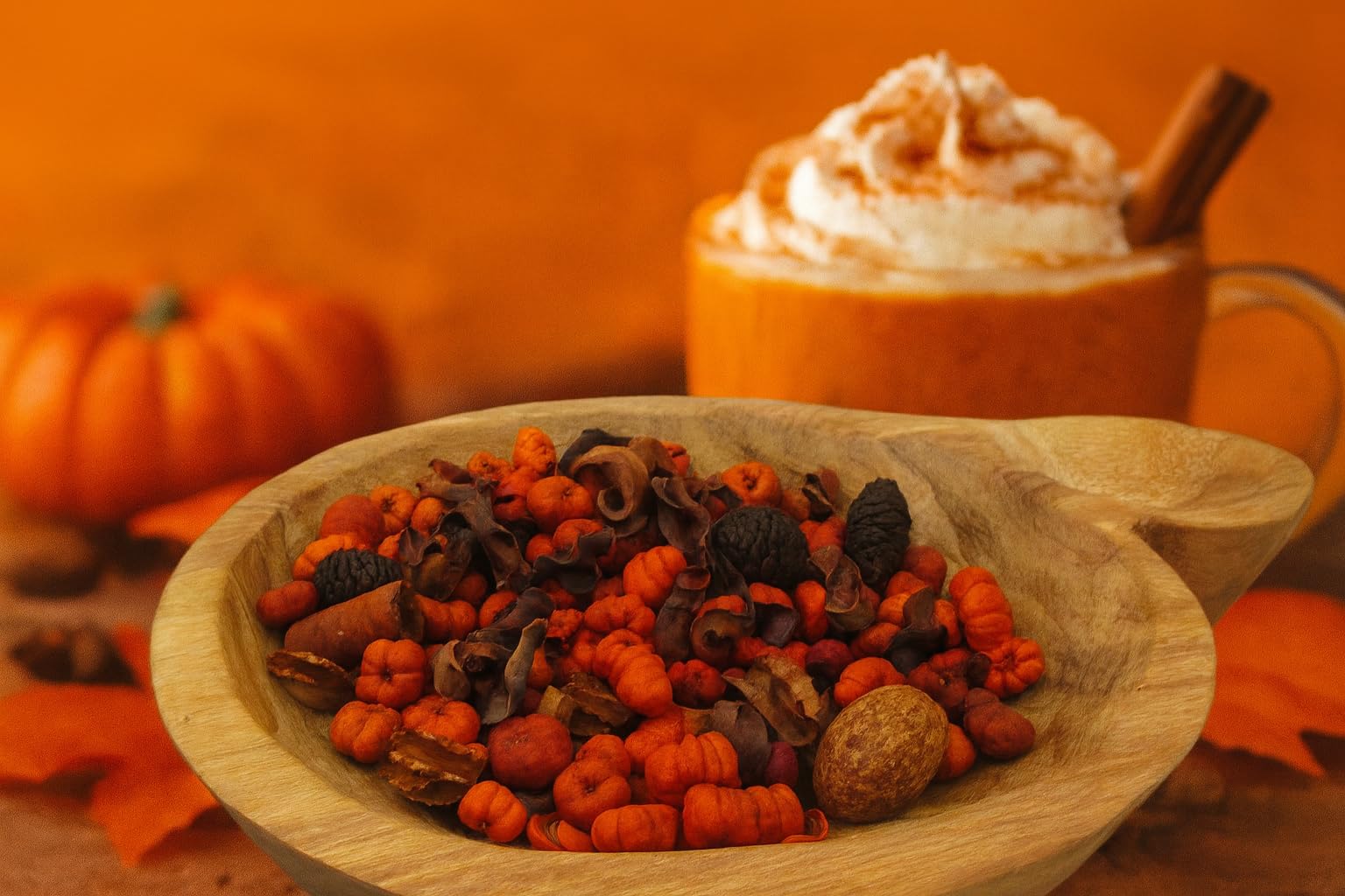 Wooden bowl filled with fall potpourri with orange putka pods and cozy seasonal decor