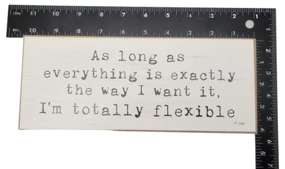 Funny wooden block sign with quote about flexibility in black text on white background