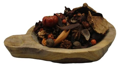 Pumpkin spice potpourri with dried leaves and miniature pumpkins in a rustic wooden bowl