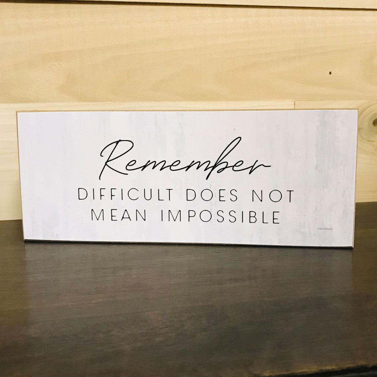 Motivational wood block sign with inspirational quote 'Remember Difficult Does Not Mean Impossible'