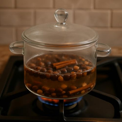 Nutty vanilla simmer potpourri in a glass pot with spices simmering on a stovetop