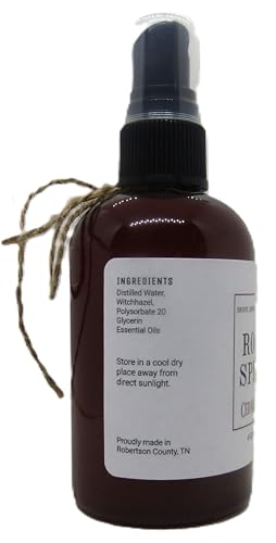 Dark amber spray bottle of cedarwood room spray with black pump and natural twine detail