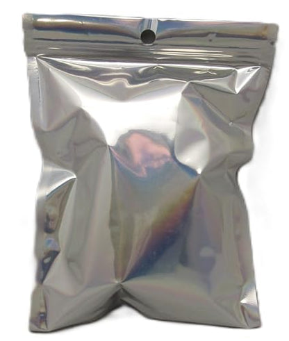 Silver pouch containing orange patchouli sachet for freshening up home spaces