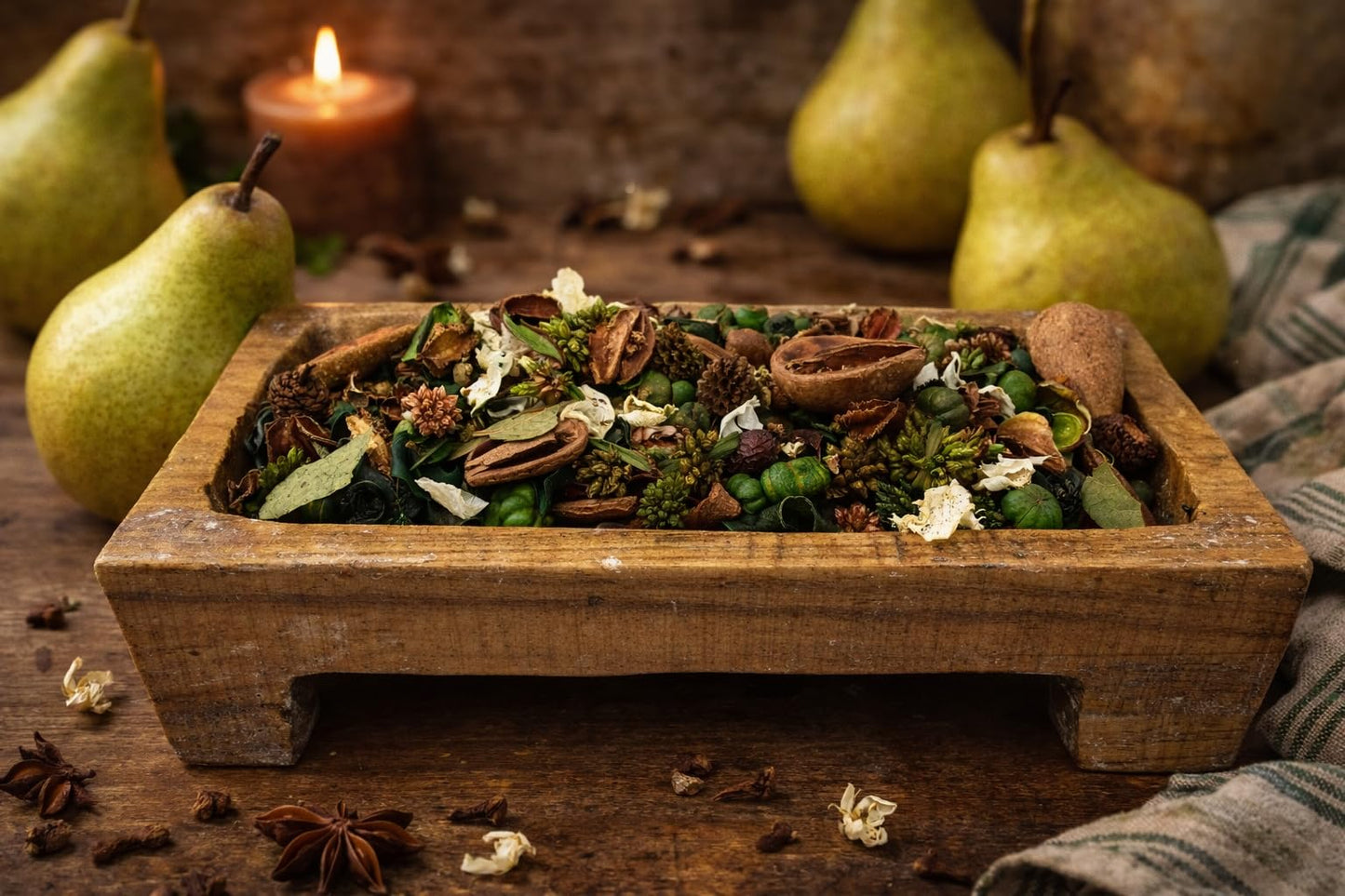 Natural spiced bartlett pear potpourri in a wooden bowl with seasonal decorative elements