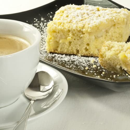 Spiced coffee cake room spray concept with a cup of coffee and crumbly coffee cake dusted with powdered sugar
