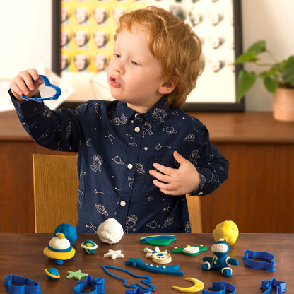 Child playing with Family Games America scented modeling dough kit using blue cutters and colorful dough shapes
