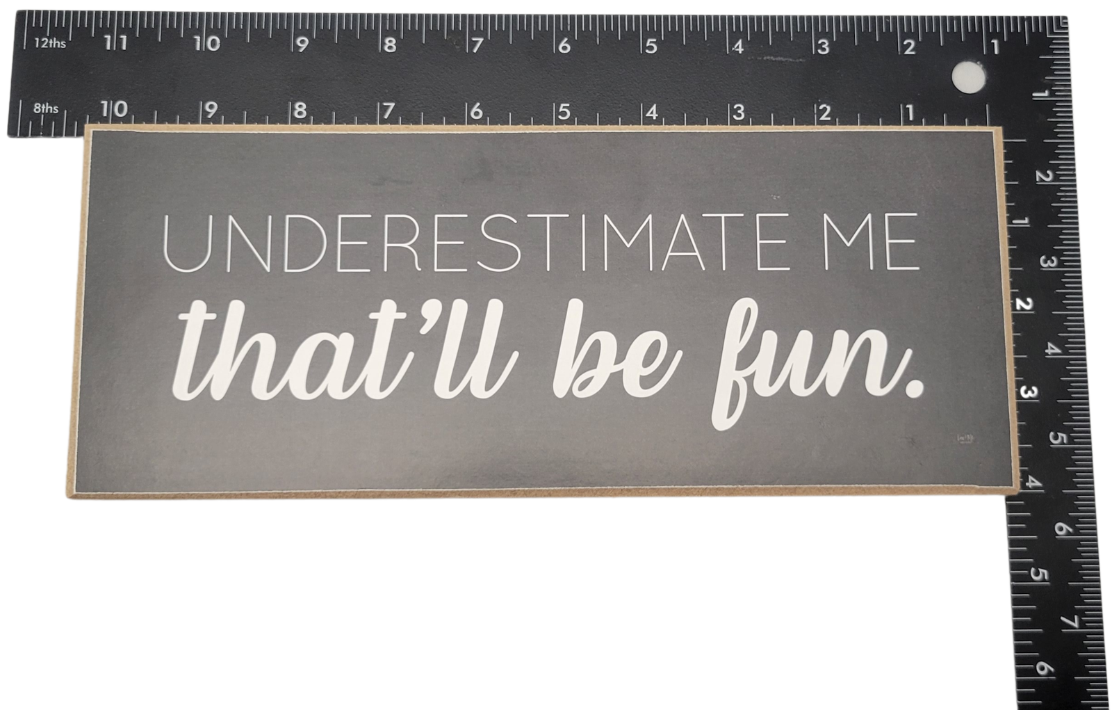 Underestimate me that will be fun sign in white text on black background home decor piece