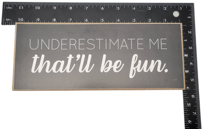 Underestimate me that will be fun sign in white text on black background home decor piece