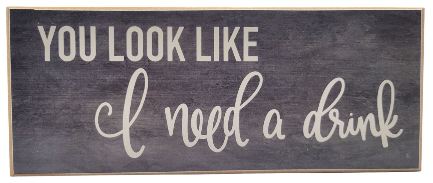 Jan Michaels Art & Home wooden wall sign with the phrase you look like i need a drink in white lettering